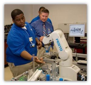 Daniel Horine, center, teaches students in the mechatronics lab at Virginia Western Community College.