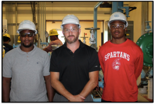 Indian River State College graduates Tyrone Joseph (left) and Hykeem Spencer (right) were among the students who successfully completed the contextualized math course developed by Kevin Cooper (center), principal investigator of the Regional Center for Nuclear Education and Training (RCNET).