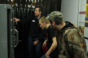 Andrew Kott, left, uses industry-grade equipment and a small-scale simulation of an automated distribution center in Chippewa Valley Technical College’s Mobile Manufacturing Lab to teach rural high school students about Industry 4.0 concepts and the Industrial Internet of Things. 