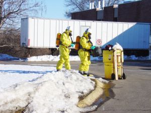 Environmental health and safety technicians practice with simulated hazardous materials during ATEEC environmental education programs.  