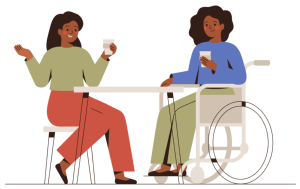 A woman in a wheel chair and a woman seated at a table share coffee and converse.