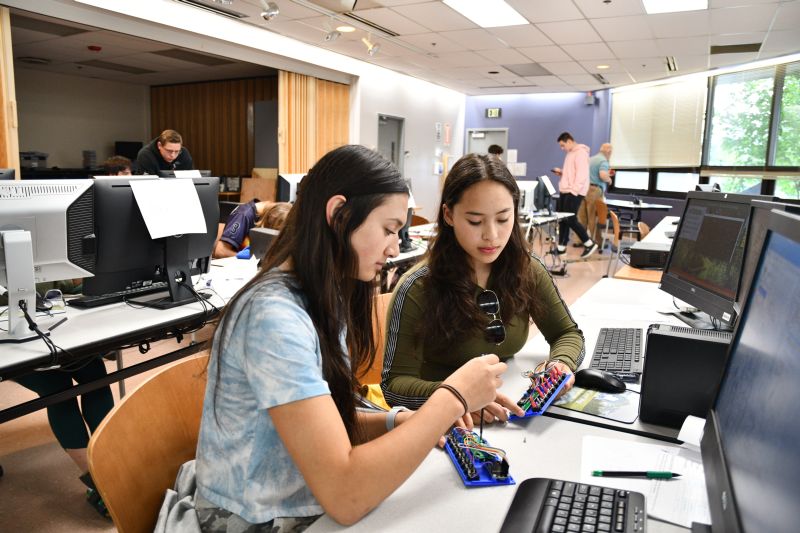 Alaska Tech Learners (ATL) is featured in ATE Impacts 2022-2023, with this photo of students learning web engineering.