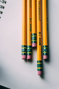 A close up photo of several yellow pencils