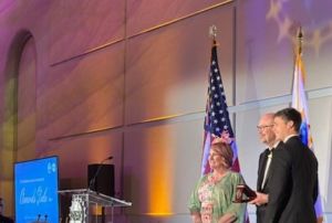 McGuffin and Wooldridge receive the award from NSB Chair Dan Reed in the Renwick Gallery, Washington, D.C.  